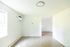 Bright and open living space with elegant wood flooring and large windows, perfect for modern living comfort.