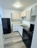 Modern kitchen with sleek black appliances, elegant cabinetry, and spacious countertops, perfect for culinary enthusiasts.