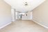 Spacious open-concept living area with modern kitchen and sleek hardwood floors, perfect for contemporary living.