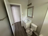 Bright and welcoming bathroom featuring modern fixtures, elegant mirror, and sleek wood flooring.