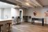 Modern game lounge with a sleek bar area, foosball table, and contemporary seating.