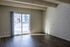 Sunlit room with sliding glass doors and modern brick wall design.