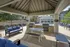 Inviting outdoor lounge with stylish seating, barbecue grills, and a sparkling pool, perfect for relaxing and entertaining in a beautiful setting.