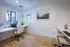 Bright home office with sleek dual desks, modern decor, and abundant natural light.