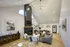 Charming living room with high ceilings, elegant chandelier, and cozy fireplace, perfect for relaxing.