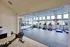 Elegant fitness room with modern exercise equipment, bright natural light, and sleek flooring, perfect for energizing workouts.