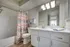 Modern bathroom featuring a sleek marble countertop, elegant vanity, and vibrant shower curtain.