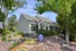 Charming leasing office surrounded by lush greenery and vibrant landscape, inviting entryway with bright yellow stairs.