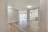 Bright open-concept living area with elegant hardwood flooring, modern kitchen, and large windows offering stunning city views.