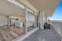 Contemporary open-plan kitchen with sleek finishes connected to a spacious balcony offering stunning panoramic views.