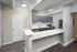 Modern kitchen with sleek gray cabinetry, stainless steel appliances, and a spacious countertop ideal for meal prep and casual dining.