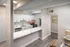 Modern kitchen with sleek white cabinetry, stainless steel appliances, and elegant marble countertops in a bright, inviting space.