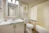Elegant and modern bathroom featuring a stylish vanity with a marble countertop, a framed mirror, and a chic shower curtain for a sophisticated touch.