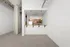 Modern apartment interior with elegant open kitchen, featuring sleek wooden cabinetry, stainless steel appliances, and stylish pendant lighting.