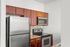Contemporary kitchen with sleek stainless steel appliances, elegant wooden cabinetry, and stylish granite countertops.
