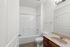 Bright and modern bathroom featuring a pristine bathtub, elegant sink, and sleek fixtures.