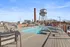 Chic rooftop pool area with modern loungers and industrial views, perfect for relaxation and enjoying the sunny skyline.