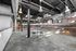 Modern industrial loft with exposed brick walls, sleek metal ductwork, and stylish lighting, creating a trendy and open atmosphere.