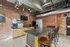 Chic industrial kitchen with exposed brick, modern appliances, and granite countertops.