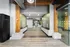Inviting lobby area with contemporary design, featuring natural wood beams, elegant tile flooring, and convenient mailboxes.