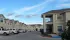 Exterior Apartment Buildings with Parked Cars and Truck Cloudy Skies View - La Joya Apartments in Laredo Texas