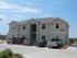 Exterior Apartment Buildings with Parked Cars and Trucks View