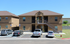 Charming two-story apartment building with elegant exterior, ample parking, and convenient access to upper-level units. Ideal for comfortable and modern living.