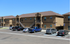 Modern apartment complex with ample parking, featuring stylish two-story design and convenient staircase access.