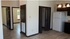 Bright and spacious apartment interior featuring modern kitchen with white fridge, elegant tile flooring, and energy-efficient lighting.