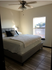 Cozy and modern bedroom with a plush bed, elegant decor, and a sunlit window offering scenic views.