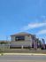 Modern apartment complex exterior, showcasing Merida Vista's sleek design and attractive location under a bright blue sky.