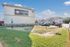 Merida Vista apartment complex exterior showcasing modern design with ample parking and lush green surroundings under a clear blue sky.