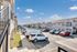 Charming apartment complex with modern architecture, ample parking, and a sunny outdoor setting.