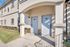 Charming apartment entrance with elegant archway and dual doors, offering a welcoming and stylish exterior.