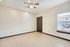 Bright living room with elegant tile flooring, modern ceiling fan, and large window inviting natural light.