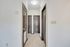 Elegant hallway with rich wooden doors and modern tile flooring, showcasing a stylish entryway.