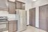 Modern kitchen with sleek stainless steel refrigerator, elegant dark cabinetry, and pristine granite countertops.