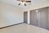 Interior view of a Merida Vista Apartments room featuring two closets and a ceiling fan in Laredo, Texas