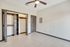Bright and airy room with elegant tile flooring, open closet space, and a modern ceiling fan, perfect for personalized styling.
