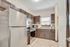 Charming kitchen with modern stainless steel appliances, elegant wooden cabinets, and ample natural light.