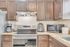 Charming kitchen with rich wooden cabinetry, modern appliances, and granite countertops, perfect for culinary creativity.