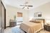 Bright and cozy bedroom featuring a comfortable bed, elegant dresser, and natural light from a window with stylish blinds, perfect for relaxation.