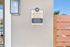Elegant entrance of La Joya Apartments showcasing office hours and contact details.