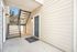Welcoming apartment entrance with a modern blue door and stylish outdoor staircase, offering a serene and private atmosphere.