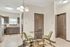 Charming kitchen nook with modern stainless steel appliances, elegant cabinetry, and cozy seating area on a stylish patterned rug.