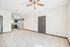 Bright open-concept living space with modern kitchen, featuring sleek cabinetry, stainless steel appliances, and elegant ceiling fan.