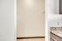 Bright walk-in closet entryway with sleek granite countertop nearby, perfect for ample storage and modern living.