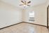 Bright and inviting room with elegant tile flooring and a ceiling fan; ideal for a cozy home ambiance.