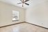 Bright, open room with modern ceiling fan and elegant tile flooring, perfect for creative interior design.