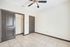 Bright and inviting room with sleek tile flooring, modern ceiling fan, and ample closet space.